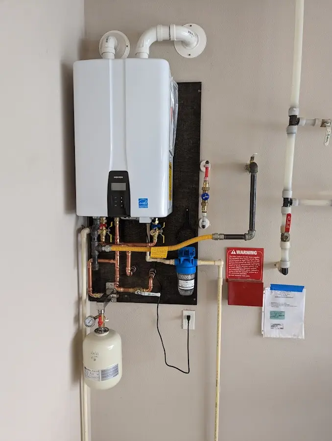 Professional plumber installing copper piping in a Dacula home